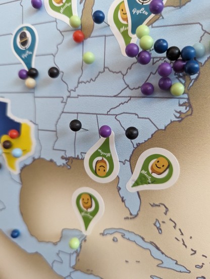 Map of the world from the PSF booth with a pin and sticker indicating the location of Atlanta Georgia