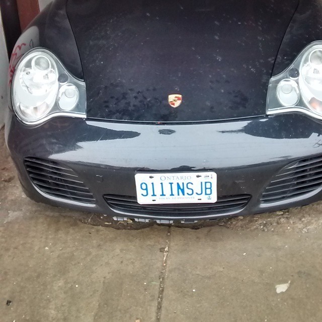 A porsche 911 with the license plate “911INSJB” (9/11 INSIDE JOB)