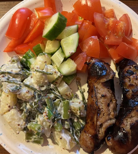 Sausages (pork and marmalade), tater salad (tater, green beans, spring onions, samphire), bell pepper, cucumber, and tomato. The tater salad also contains garlic paste and mustard, which may or may not count as vegetables.