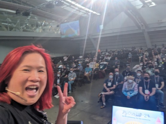 Mariatta selfie on PyCon US 2024 stage with the 2000 audience behind her