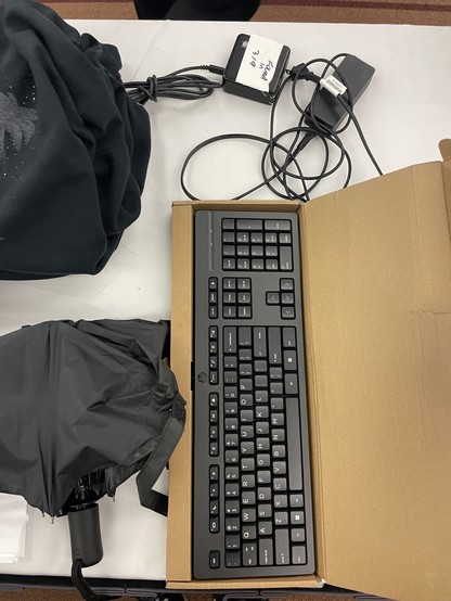 An external keyboard, a cable labeled "Found in 319", another cable