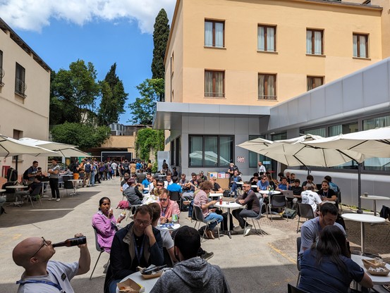 People eating at tables outside 