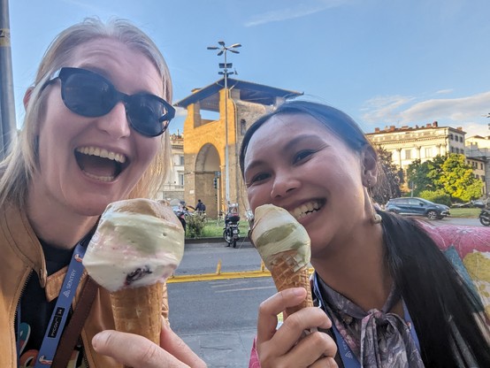 Jodie and Check posing with icecream in front of a Florence street scene.