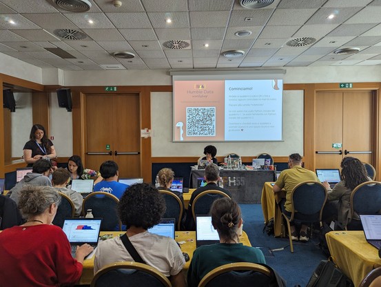 Room full of people completing a data science workshop.