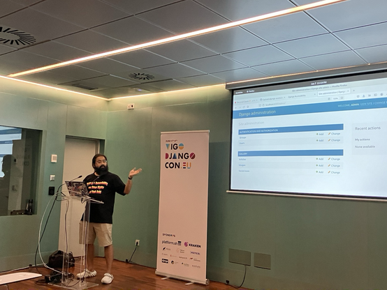 Saptak on stage, with the Django admin on screen