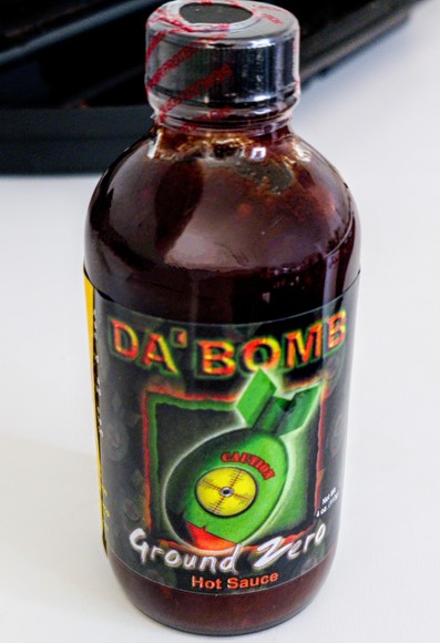 Hot sauce bottle Da' Bomb Ground Zero.
Label shows a big green bomb falling down. 4 oz (113g).