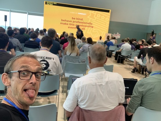 Selfie from in the crowd before the first keynote at DjangoCon Europe 2024. I’m looking back, and happen to have my tongue out 😜