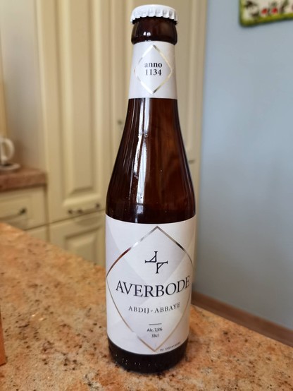 A bottle of Averbode blond beer on a kitchen counter.