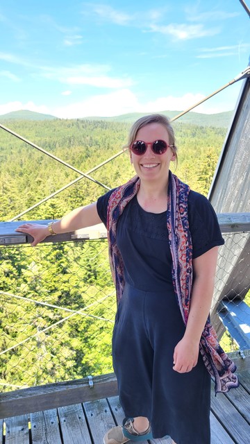 Heidi with a hilly forest in the background 