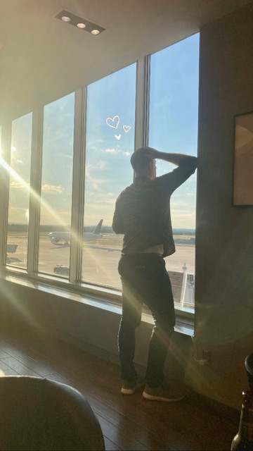 Man in front of a window at the airport