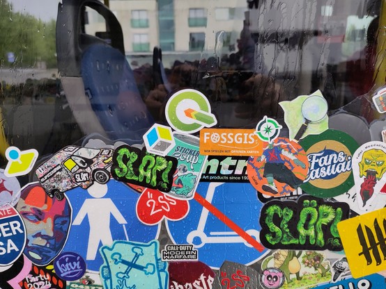 There's a bus in Tartu that is completely covered by stickers.
The picture shows some stickers from FOSS4G projects.