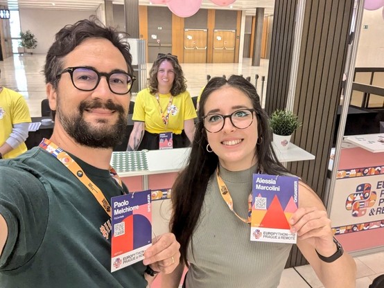 Paolo and Alessia at the conference desk