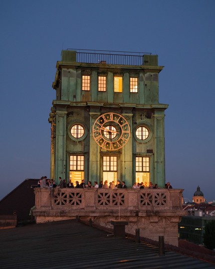 the clock tower at night - illuminated in our trademark yellow color 