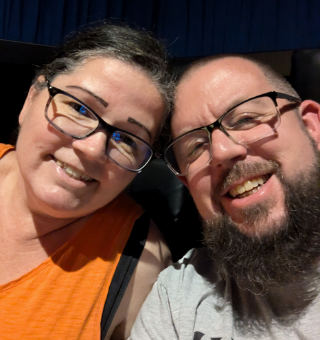 two people sitting in a movie theater 