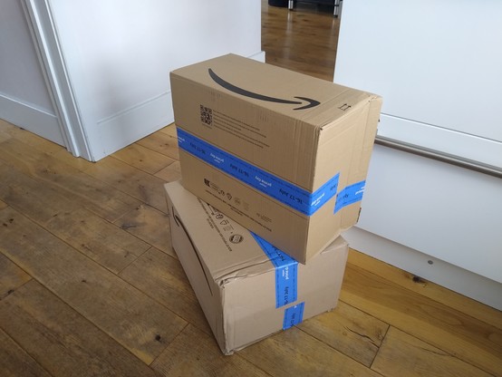 Pair of large cardboard boxes, with Amazon branding.