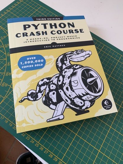 Python Crash Course 3rd Edition sitting on my desk. 