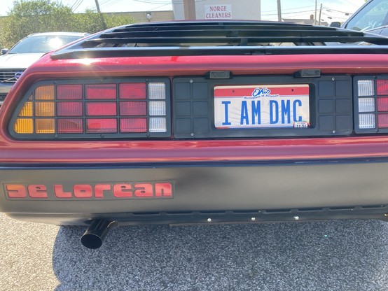 Rear view of a DeLorean in a parking lot.  Ohio license plate says 