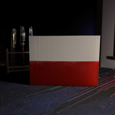 A 3D print of the Polish flag on a desk.