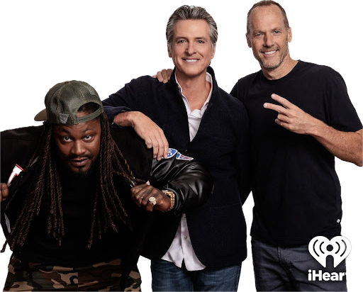 Gavin newsom, Marshawn Lynch and Doug Hendrickson pose for their new podcast. Newsom is leaning on Lynch who is holding the lapels of his coat while Hendrickson stands behind newsom holding up a peace sign. The iHeart Radio logo is in the bottom corner. 