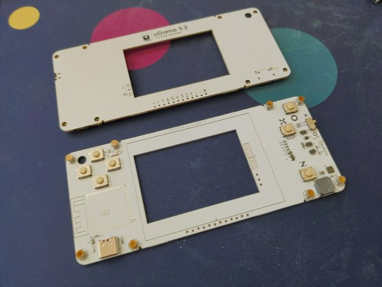 two partially assembled PCBs for a handheld console