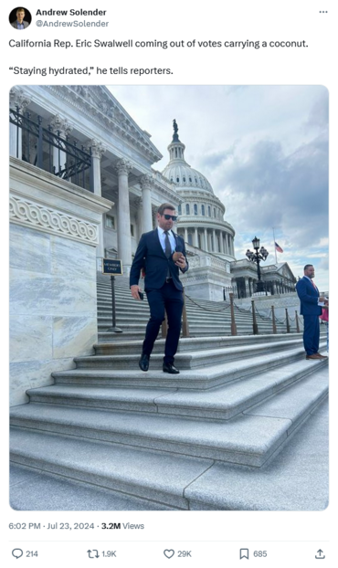 Tweet from Andrew Solender, showing Rep. Eric Swalwell coming down the Capitol steps, coconut in hand.
