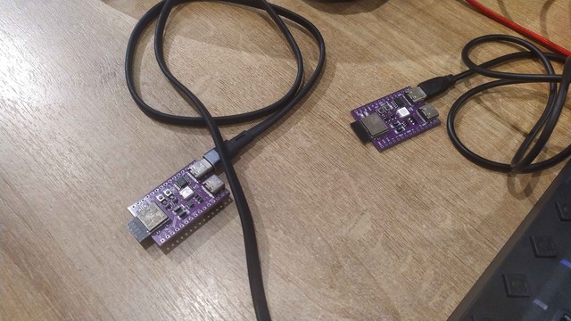Two ESP32-C3 devkit boards next to each other on the desk. It is plugged to a computer.