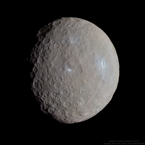An image of Ceres taken by NASA's spacecraft Dawn. It's a small world with a surface full of craters, some of which show icy patches reflecting sunlight. The color is quite greyish.