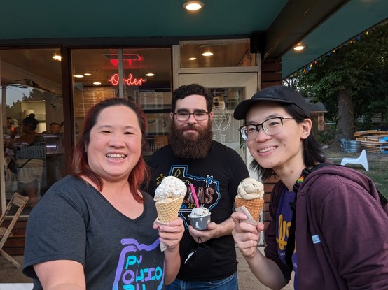 Three people posing for photo, each of them holding ice cream cone/ cup.
Left to right: Mariatta, Jon Banafato, Elaine Wing