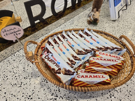 Kinder Buenos and Tunnocks Caramel logs in a basket with a sign that says 