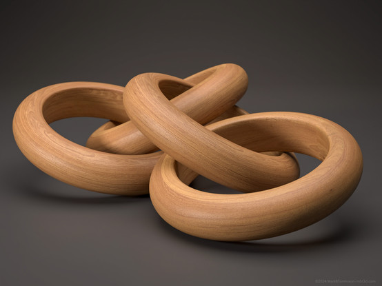 Four intertwined wooden rings collapsed on a grey surface.