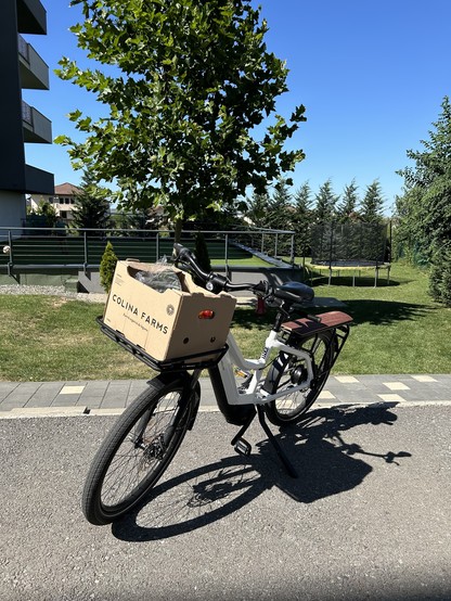 A white Riese Muller cargo bike with cartboard box at the front. 