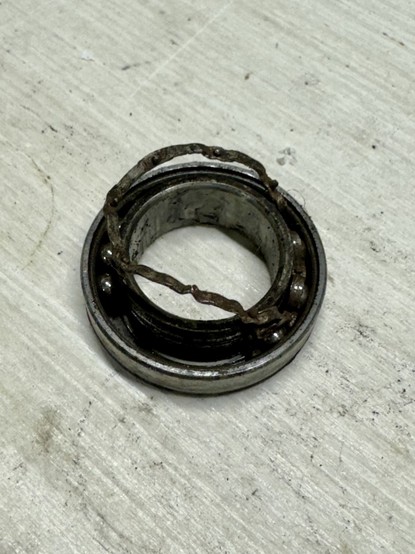 Bottom bracket ball bearing with a destroyed cage.