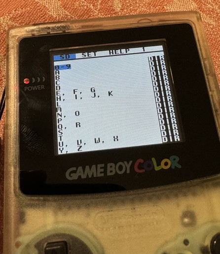 A Gameboy Color showing the EZ Flash Junior folder/ROM selection screen. The folders are “0-9”, A, B, C etc. and some combined folders like “E, F, G” and similar.