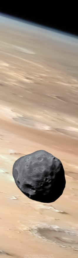 An image of Phobos taken by the ESA Mars Express over the surface of Mars shows the rusty red, crater-filled Martian landscape, with the atmosphere visible on the limb. Phobos, shaped like a potato and appearing grey, also displays its craters
