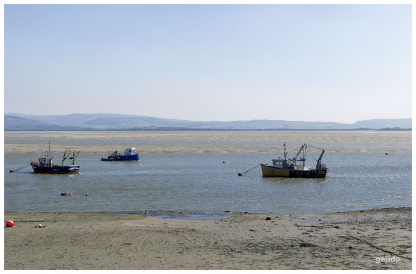 Three boats on the river estuary