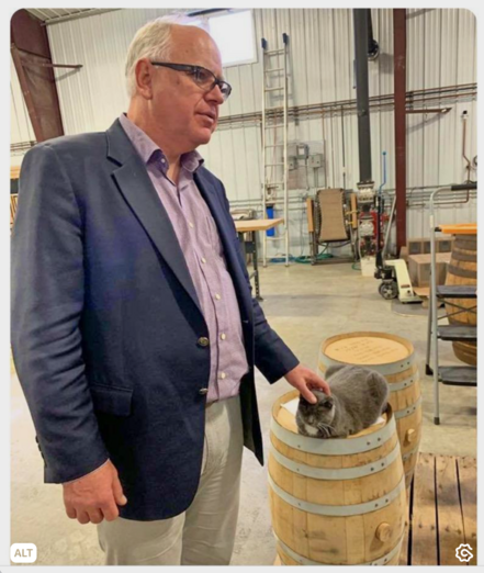 Tim Walz petting a cat at a campaign stop a few years back.