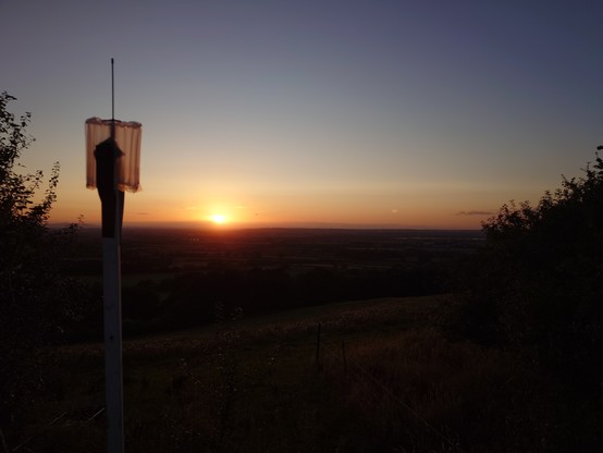 sunset behind a glorious node on a pole