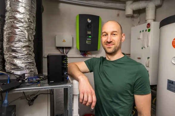 Arne in his home utility room in front of a solar inverter.