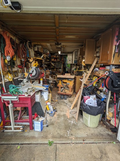 very full single car garage
sawdust all over the floor
all available floor space taken by the table saw