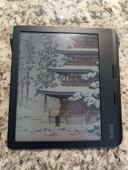 Kobo ereader in screensaver mode. Japanese temple in winter with a woman in front holding an umbrella.