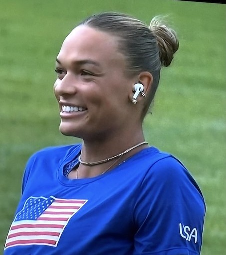 Olympic athlete using Apple AirPods for interview.