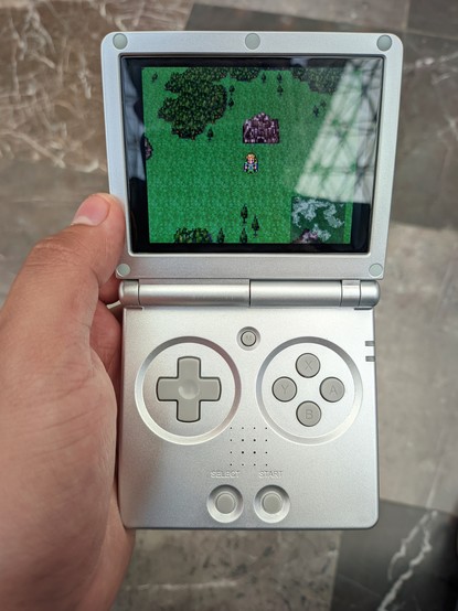 A silver-colored retro handheld device