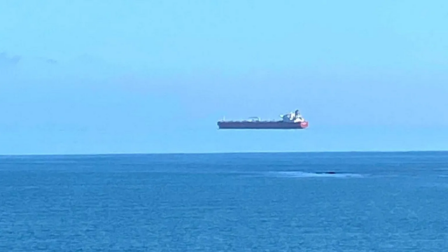 An optical illusion caused the ship to appear as though it was hovering above the horizon