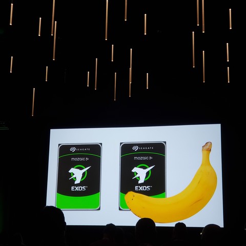 Image of banana in front of very large hard disks that can store 60 TB together