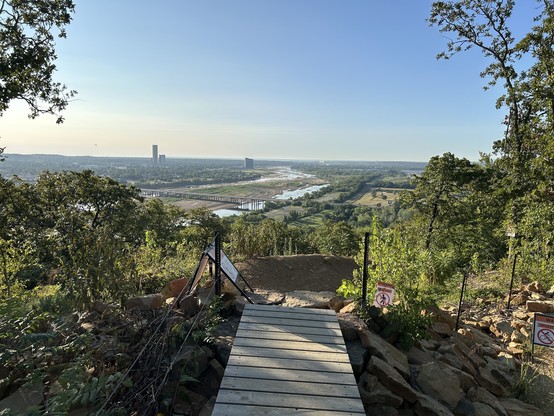 A view of the Tulsa skyline, a bridge A mountain biking trail