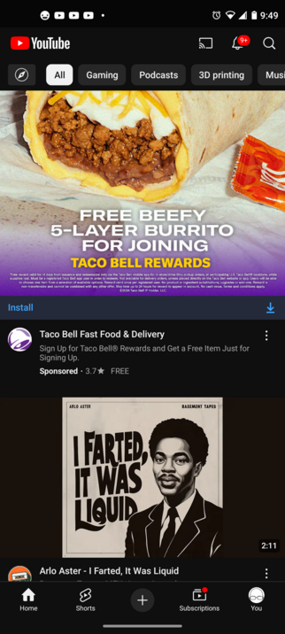 A screenshot of the YouTube app on a phone. The top of the screen shows an ad for a free beefy 5-layer burrito. The bottom of the screen shows the cover for a record: 