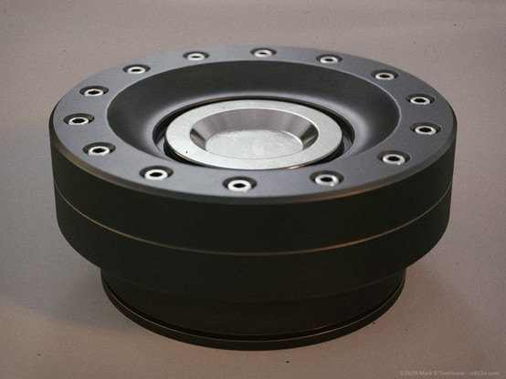 circular form with a radial array of small hex bolts around the top and a bright metal insert in the center