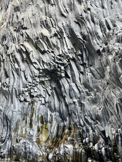 A surprising rock formation in Alcantara Gorge, Sicilia. Rocks look like a frozen liquid, or thick pages of a book.