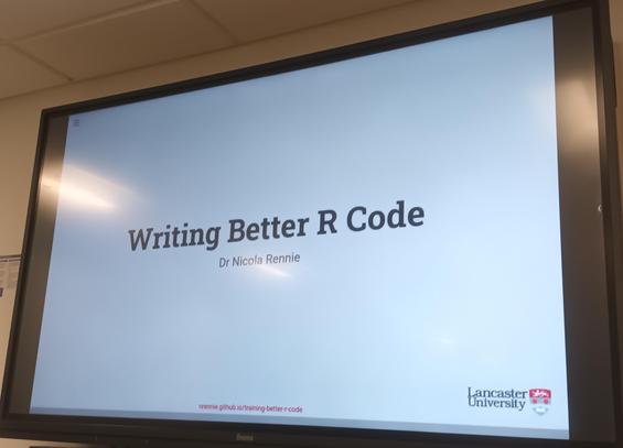 Photo of TV screen showing a slide with the title Writing Better R Code