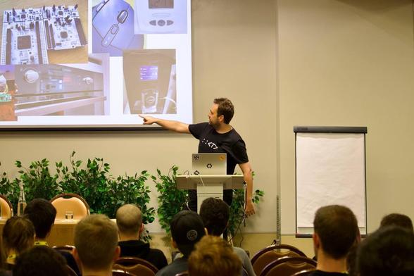 Picture shows Tamme pointing to all kinds of every day devices that contain embedded software on chips.